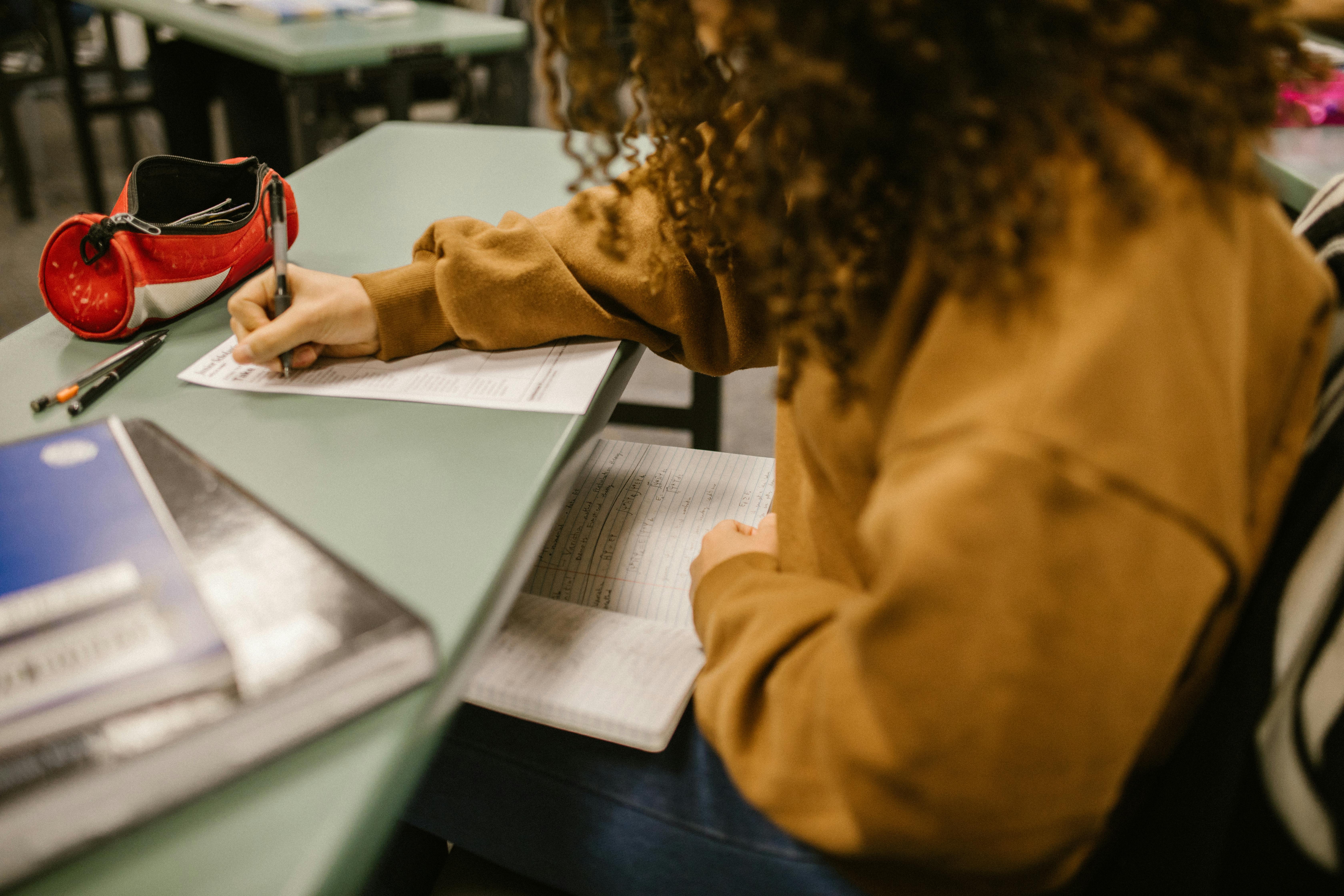 Student writing during an exam session